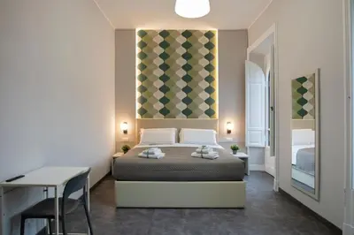 a bedroom with a bed and a table and a desk at DoppioSei in Rome