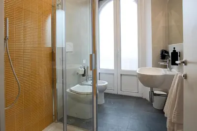 a bathroom with a glass shower and a sink at DoppioSei in Rome