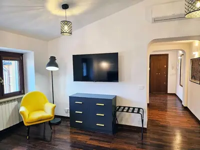 a living room with a blue dresser and a yellow chair at Gabri 19 - Elegant Escape in Piazzale Flaminio in Rome