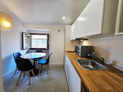 a kitchen with a sink and a table with chairs at Gabri 19 - Elegant Escape in Piazzale Flaminio in Rome