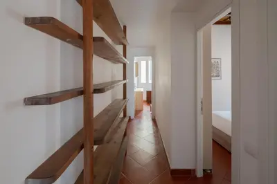 a hallway with wooden shelves in a room with a bed at Colosseum Apt in Rome