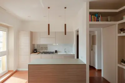 a kitchen with white cabinets and a counter top at Colosseum Apt in Rome