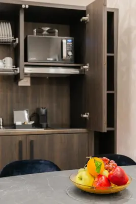 a bowl of fruit on a table in a kitchen at H77 Apartments - Maison D'Art Collection in Rome