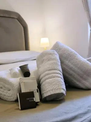 a bed with towels and a box on it at Vicolo di Monte del Gallo 24 - Vatican City in Rome