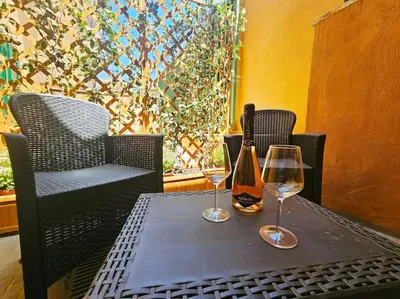 a table with two wine glasses and a bottle on it at Vicolo di Monte del Gallo 24 - Vatican City in Rome
