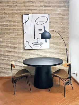 a table with two chairs and a lamp next to a brick wall at Vicolo dell'Atleta 23 - Garden in Trastevere in Rome
