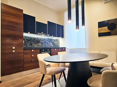 a kitchen with a table and chairs in a room at Lungotevere Testaccio 11 - Amazing Flat in Rome in Rome