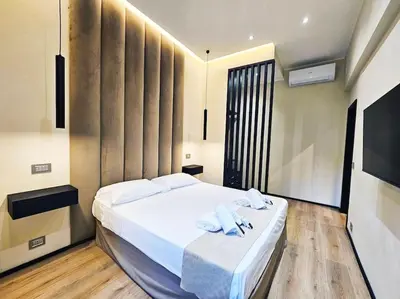 a bedroom with a large white bed with towels on it at Lungotevere Testaccio 11 - Amazing Flat in Rome in Rome