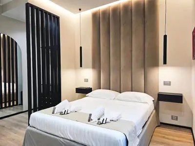 a bedroom with a large bed with white pillows at Lungotevere Testaccio 11 - Amazing Flat in Rome in Rome