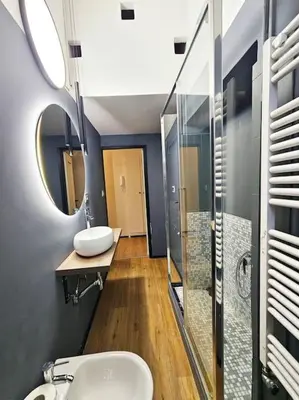 a bathroom with two sinks and a mirror at Lungotevere Testaccio 11 - Amazing Flat in Rome in Rome