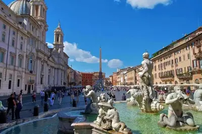 a fountain in a city with people walking around it at Central and Historic Rione near Colosseo in Rome
