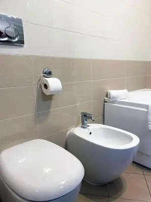 a bathroom with a bed and a sink and a mirror at Casa Beatriz - Amazing Apartment in Rome in Rome