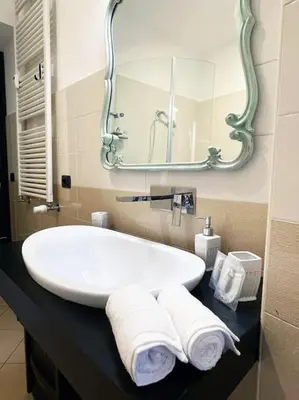 a bedroom with a bed with two towels on it at Casa Beatriz - Amazing Apartment in Rome in Rome