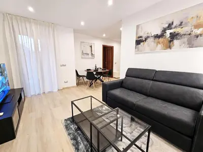 a living room with a black couch and a table at Carlo Rusconi 10 - Trastevere in Rome