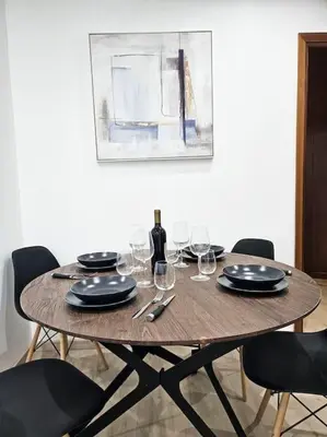 a wooden table with glasses and a bottle of wine at Carlo Rusconi 10 - Trastevere in Rome