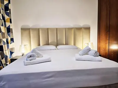 a bedroom with a large white bed with towels on it at Carlo Rusconi 10 - Trastevere in Rome