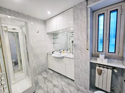 a white bathroom with a sink and a mirror at Carlo Rusconi 10 - Trastevere in Rome