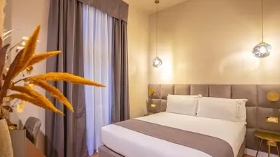 a bedroom with a bed and a large window at Navona Comfort Rooms in Rome
