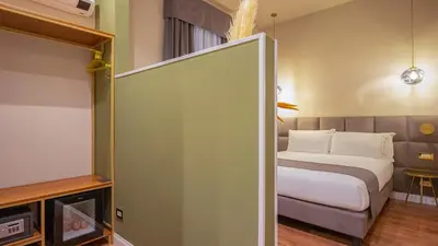 a hotel room with a bed and ajar door with a bed sidx sidx sidx at Navona Comfort Rooms in Rome