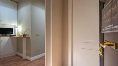 a room with a door and a desk and a television at Navona Comfort Rooms in Rome