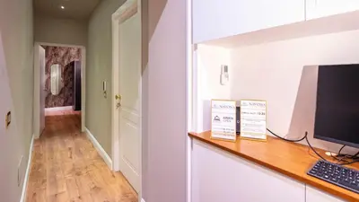 a room with a desk with a computer on a counter at Navona Comfort Rooms in Rome