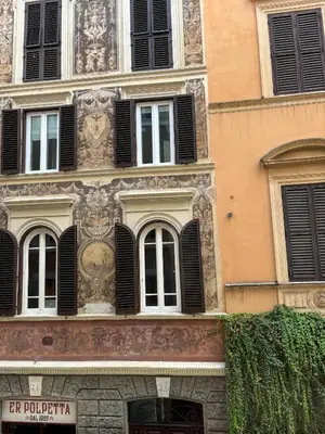 a building with black shutters on it at Navona Comfort Rooms in Rome