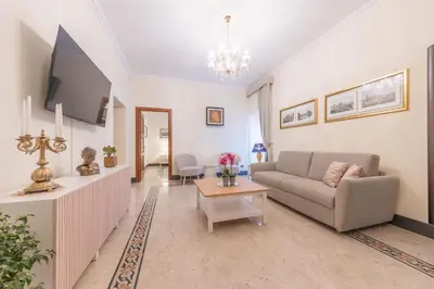a living room with a couch and a tv at St Peter's Comfort Lodge in Rome