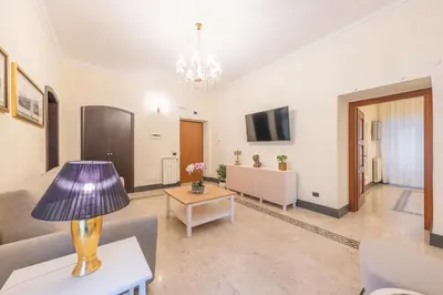 a living room with a couch and a table with a lamp at St Peter's Comfort Lodge in Rome