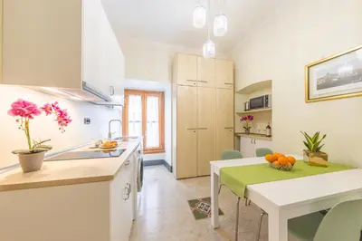 a kitchen with a table and a dining room at St Peter's Comfort Lodge in Rome