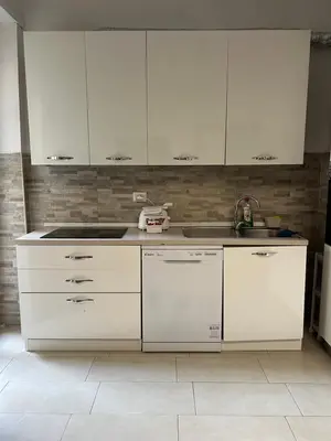 a kitchen with white cabinets and a sink at Dandon Home in Rome