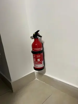 a fire extinguisher sitting on the side of a wall at Dandon Home in Rome