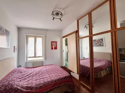 a bedroom with two beds and a mirror at Attico luminosissimo, Città Giardino - Monte Sacro in Rome