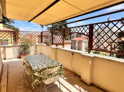 a small table on a balcony with a table at Attico luminosissimo, Città Giardino - Monte Sacro in Rome