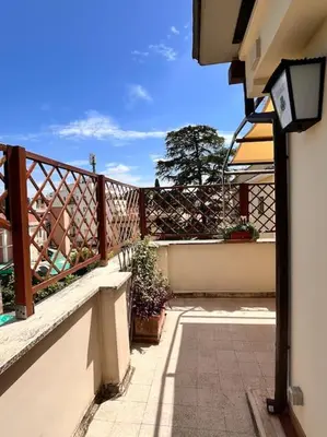 a balcony with a wooden fence and some plants at Attico luminosissimo, Città Giardino - Monte Sacro in Rome