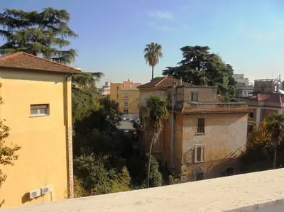 a view of a city with palm trees and buildings at Attico luminosissimo, Città Giardino - Monte Sacro in Rome
