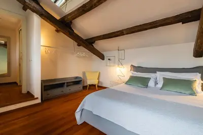 a bedroom with a large white bed and a desk at Navona 49 Luxury Suites&Apartment in Rome