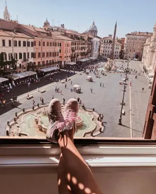 a person looking out of a window at a city street at Navona 49 Luxury Suites&Apartment in Rome