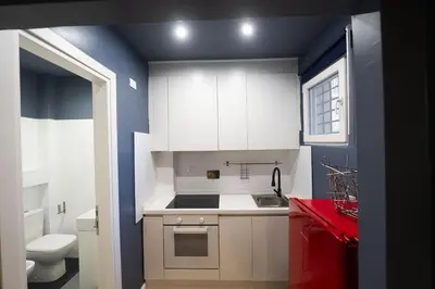 a small kitchen with a sink and a toilet at Design and Colorful Loft near Villa Pamphili in Rome