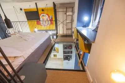 a small room with a bed and a glass floor at Design and Colorful Loft near Villa Pamphili in Rome