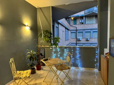 a patio with a table and chairs on a balcony at Trastevere Tales in Rome