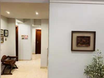 a hallway with a white wall with a picture on it at Trastevere Tales in Rome