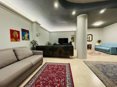 a living room with a couch and a column at Trastevere Tales in Rome