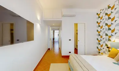 a bedroom with a bed and a couch in a room at Valery - Appartamento Glam vicino al Vaticano in Rome
