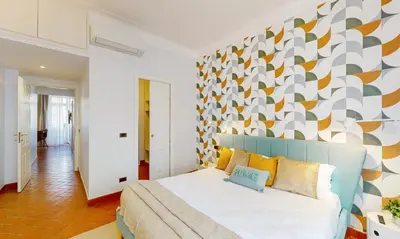 a bedroom with a bed with a colorful wall at Valery - Appartamento Glam vicino al Vaticano in Rome