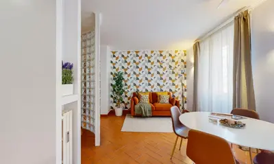 a living room with a table and a couch at Valery - Appartamento Glam vicino al Vaticano in Rome