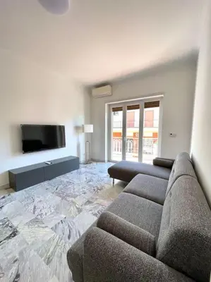 a living room with a couch and a flat screen tv at Roma Lux Apartment Lorenzo in Rome