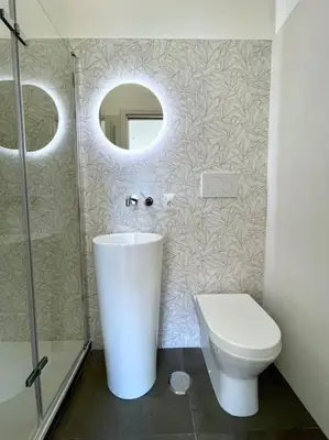 a bathroom with a toilet and a sink and a mirror at Roma Lux Apartment Lorenzo in Rome