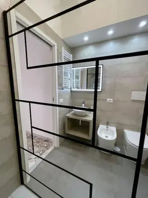 a bathroom with a sink and a toilet in it at Roma Lux Apartment Lorenzo in Rome