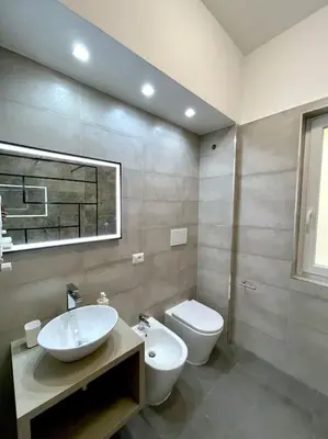 a bathroom with a sink and a toilet at Roma Lux Apartment Lorenzo in Rome