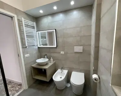 a bathroom with a toilet and a sink at Roma Lux Apartment Lorenzo in Rome